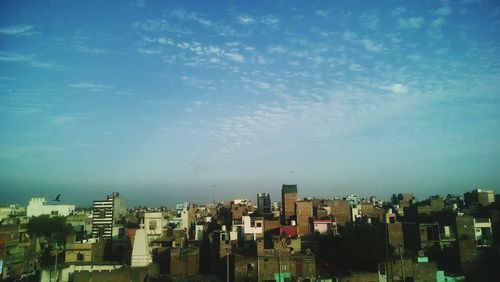 View of cityscape against blue sky