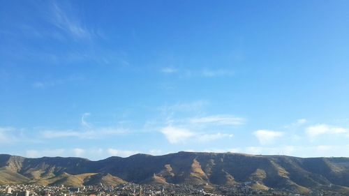 Scenic view of mountains against cloudy sky
