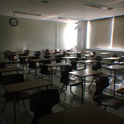 Empty chairs and tables in room