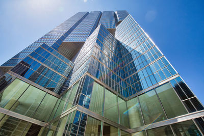 Low angle view of modern glass building against clear sky