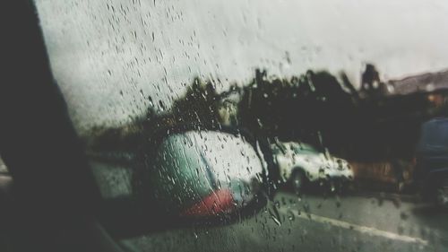 Close-up of wet car window in rainy season