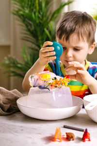 Boy removing toys from ice at home