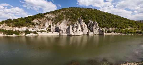 Scenic view of lake against cloudy sky