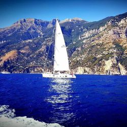 Sailboat sailing on sea against clear sky