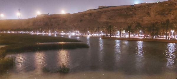 Scenic view of lake against sky at night