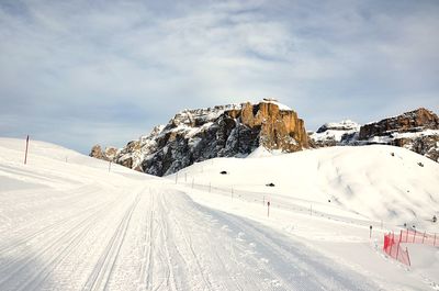 Snow covered road against sky