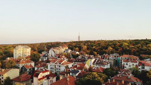 Buildings in city against clear sky