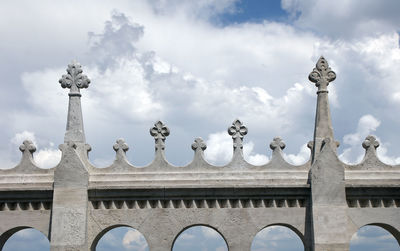 Low angle view of historical building against cloudy sky