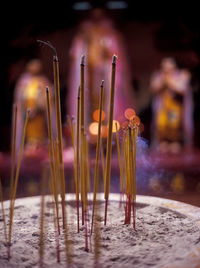 Close-up of burning candles in temple