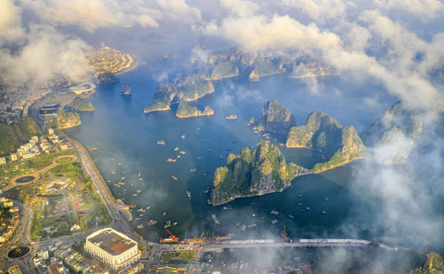 Aerial view of buildings against cloudy sky