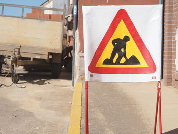 Close-up of road construction sign on sunny day