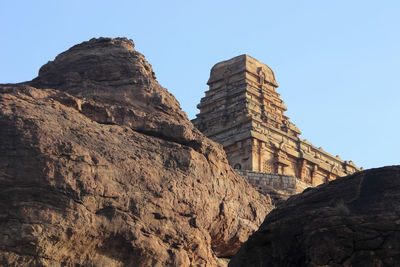 Low angle view of rock formations against sky