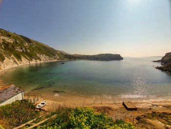 Scenic view of sea against clear sky - lulworth cove uk