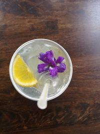 High angle view of purple flower in glass on table