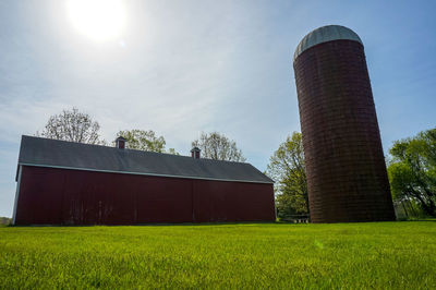 Barn on field against sky