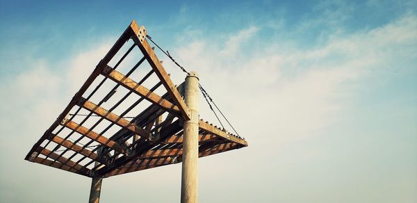 Low angle view of traditional windmill against sky