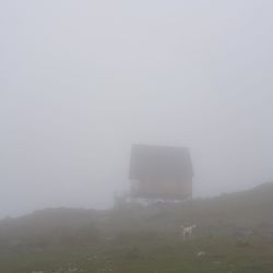 Built structure on field against sky during winter