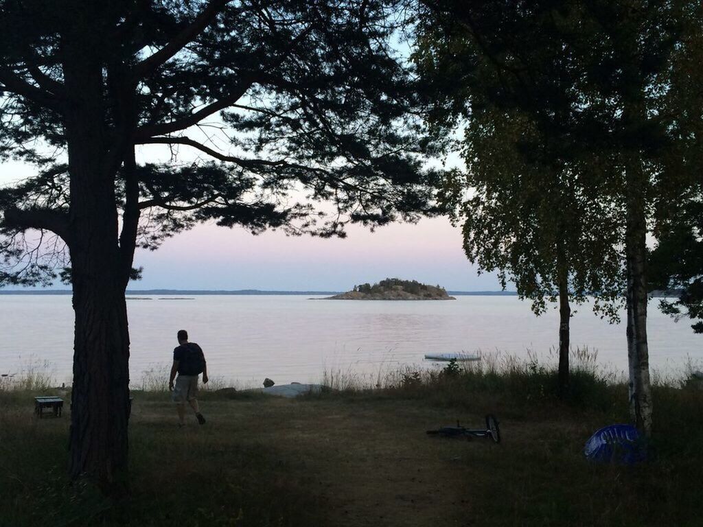 PEOPLE STANDING ON LAKESHORE