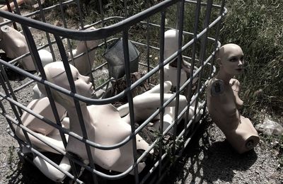High angle view of abandoned mannequin and metallic container