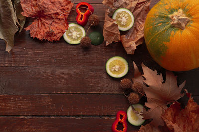 High angle view of fruits and leaves on table