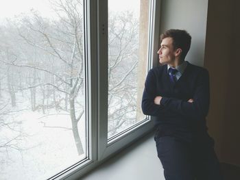 Man looking through window