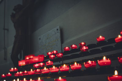 Light bulb on red wall