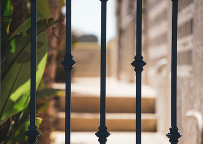 Close-up of metal railing by window