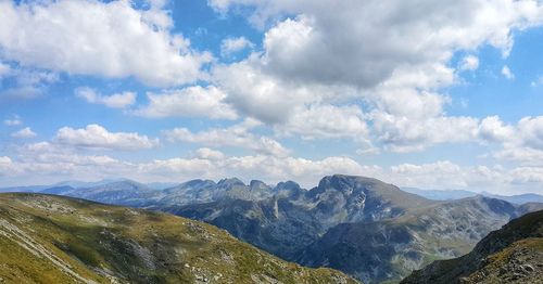 Panoramic view of mountains against cloudy sky