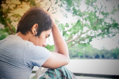 Man with closed eyes listening music outdoors