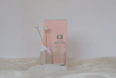 Close-up of bottle on bed at home