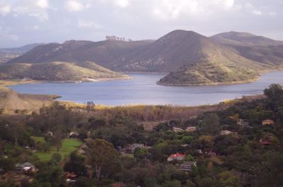 Scenic view of lake and mountains against sky