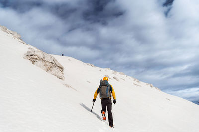 People skiing on snow covered mountain