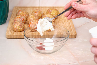 Cropped hand of person preparing food