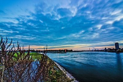 View of bridge over river against cloudy sky