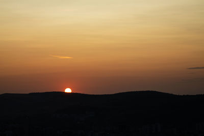 Scenic view of silhouette mountain against romantic sky at sunset