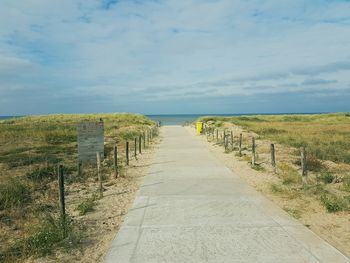 View of calm blue sea against cloudy sky