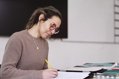 Female teacher working in classroom