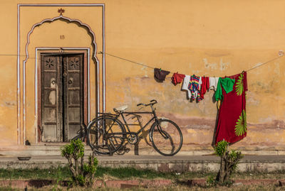 Bicycle hanging on wall against building