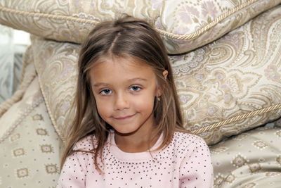 Portrait of cute smiling girl on bed