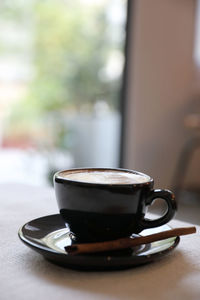 Close-up of coffee cup on table