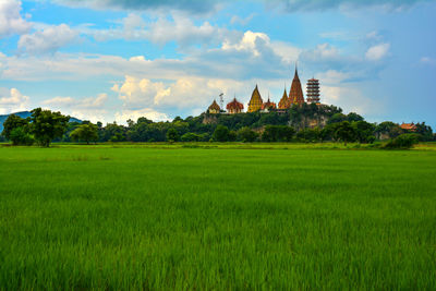 Panoramic view of temple on field against sky