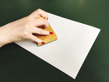 High angle view of woman stamping on paper