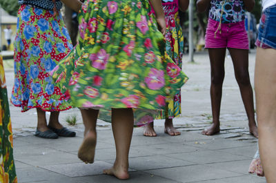 Low section of people dancing samba on street