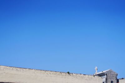 Low angle view of building against clear blue sky