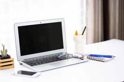 Close-up of laptop on table at home