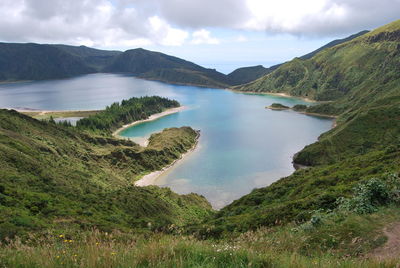 Scenic view of lake against cloudy sky