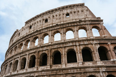 Low angle view of coliseum against sky