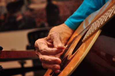 Close-up of hand holding guitar