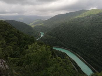 Scenic view of river amidst mountains against sky