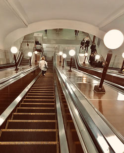 People on escalator at subway station